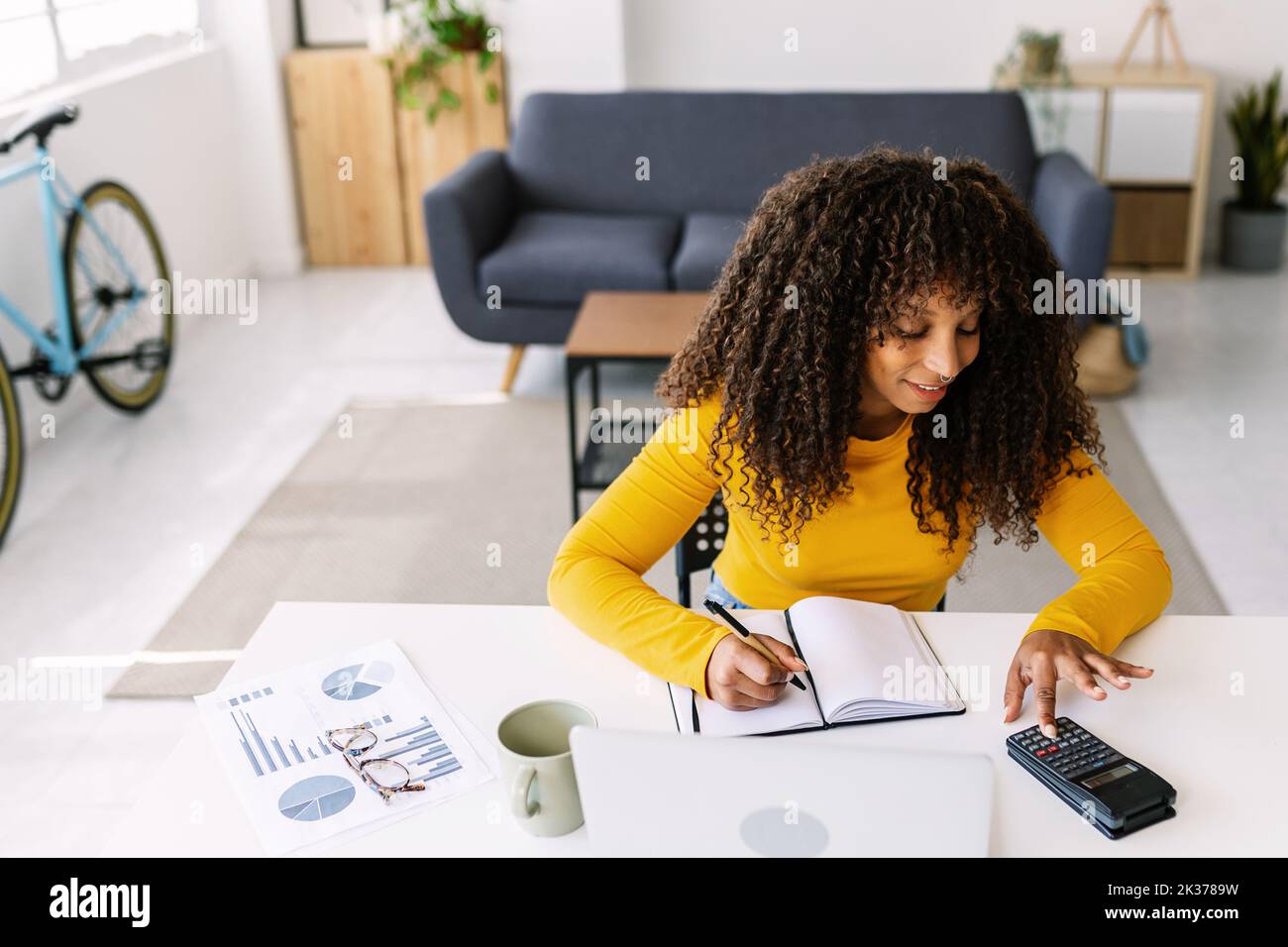 Young business ethnic woman working on laptop from home Stock Photo