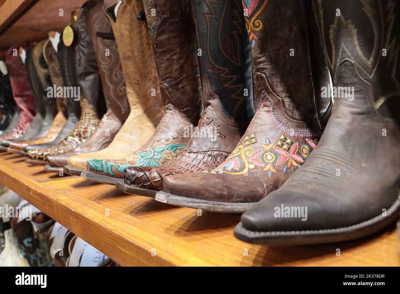 A long row of cowboy boots on sale at a store in Texas. Stock Photo