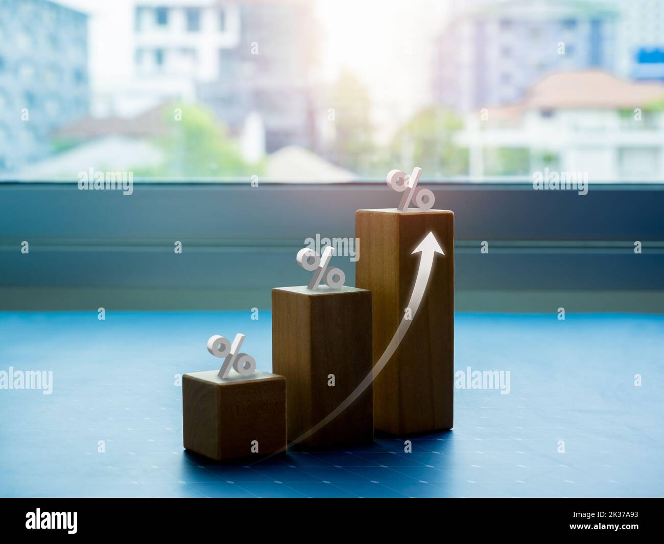 Shining rise up arrow on wooden cube blocks, bar graph chart steps with percentage 3d icons on city background, business growth process, profit, wealt Stock Photo
