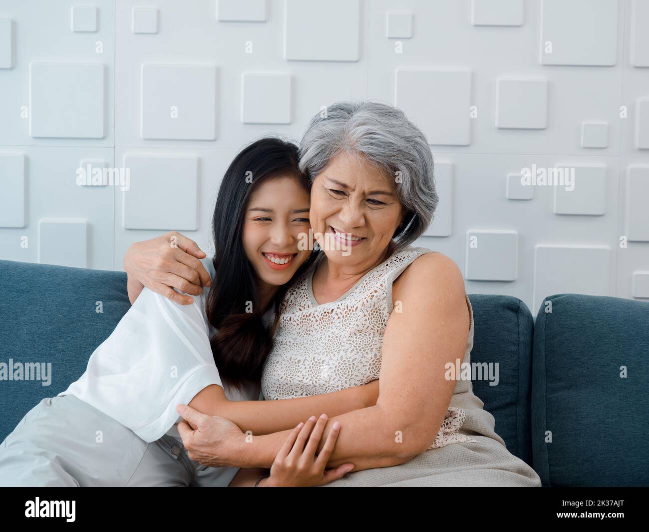 Portrait of happy Asian senior, mother or grandparent white hair embracing her beautiful daughter or grandchild smiling with love, care and comfort wh Stock Photo
