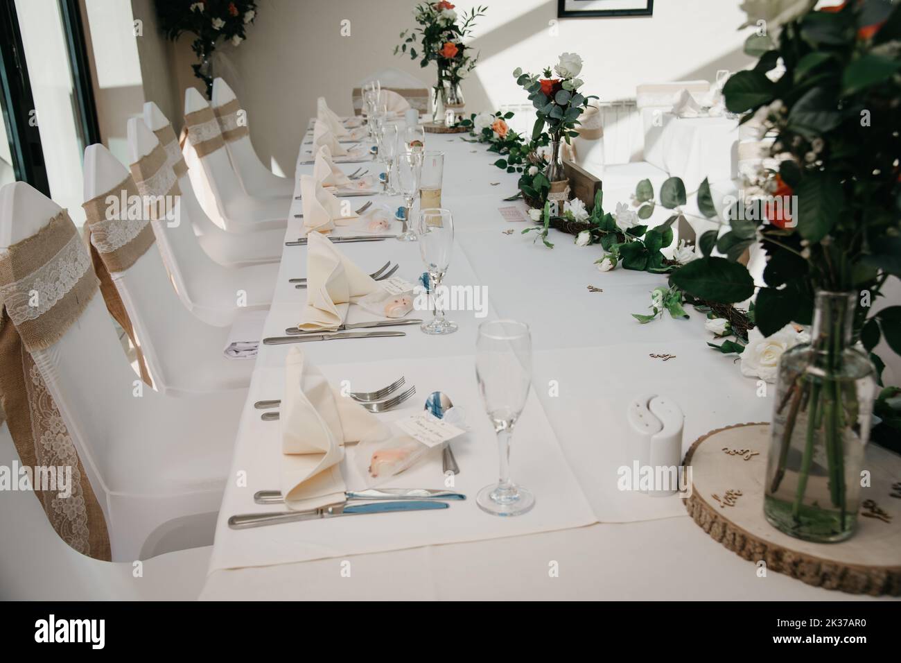 Rustic Wedding Reception Top Table seating with glasses, cutlery and