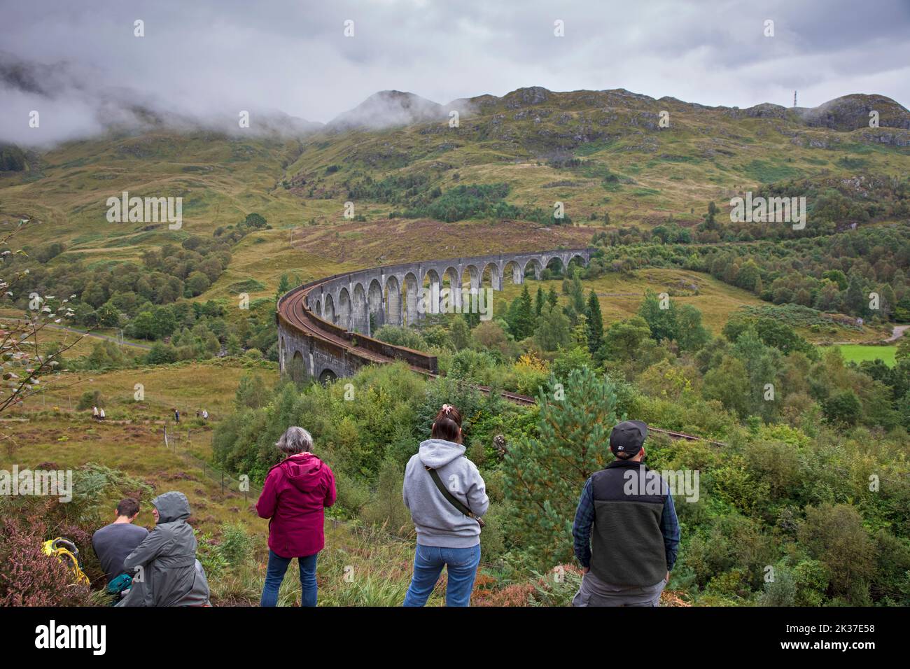 Tourists wait for Jacobite Steam Train Glenifinnan Viaduct, Lochaber, Scottish Highlands, Scotland, UK Stock Photo