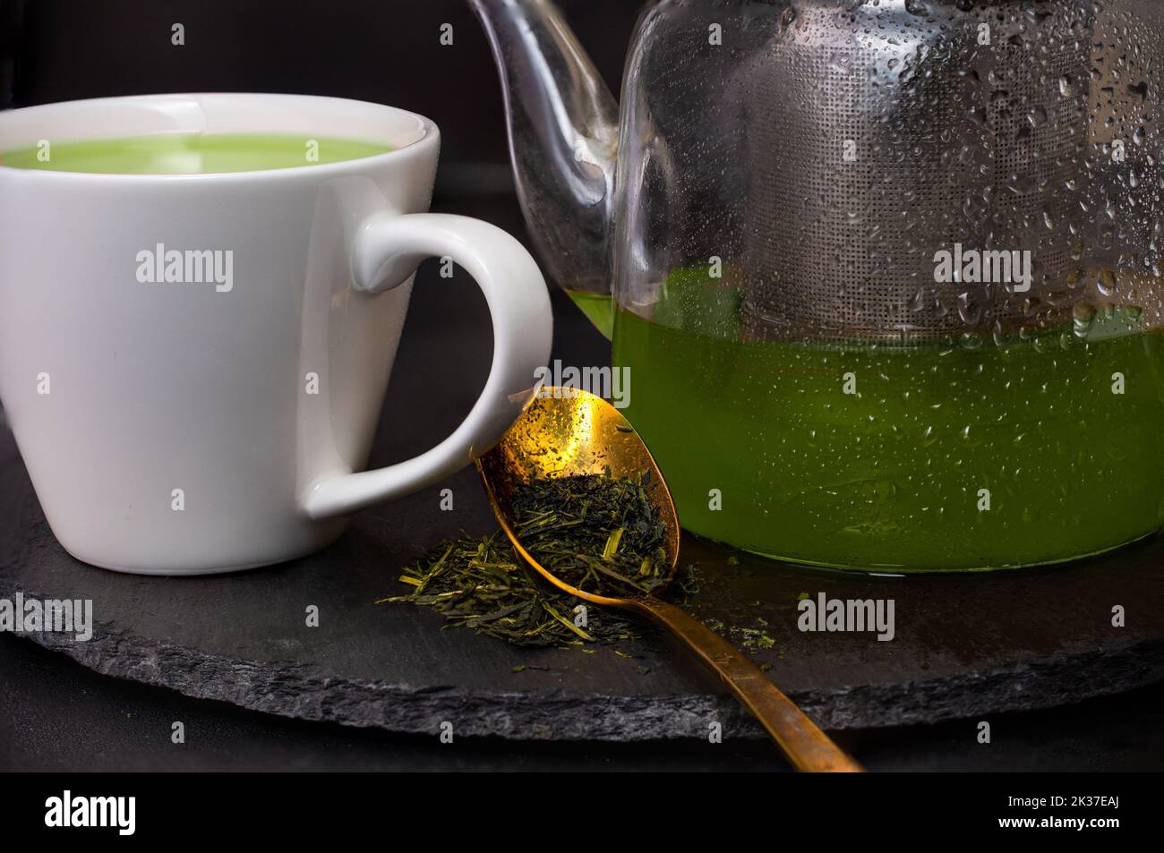 Teapot with green teas and tea leaves Stock Photo Alamy