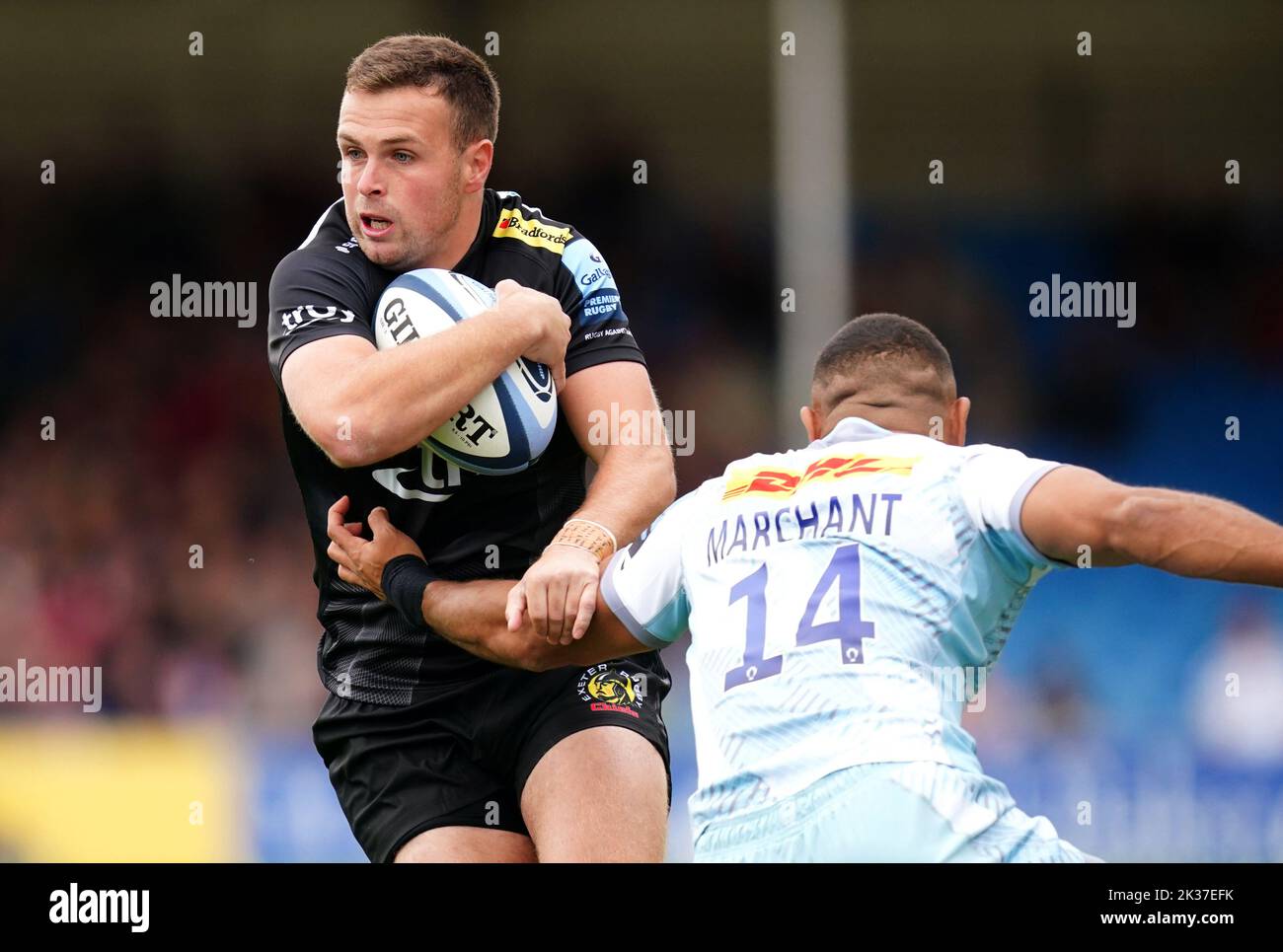 Exeter Chiefs' Joe Simmonds (left) is tackled by Harlequins' Tyrone Green Joe Marchant during the Gallagher Premiership match at Sandy Park, Exeter. Picture date: Sunday September 25, 2022. Stock Photo