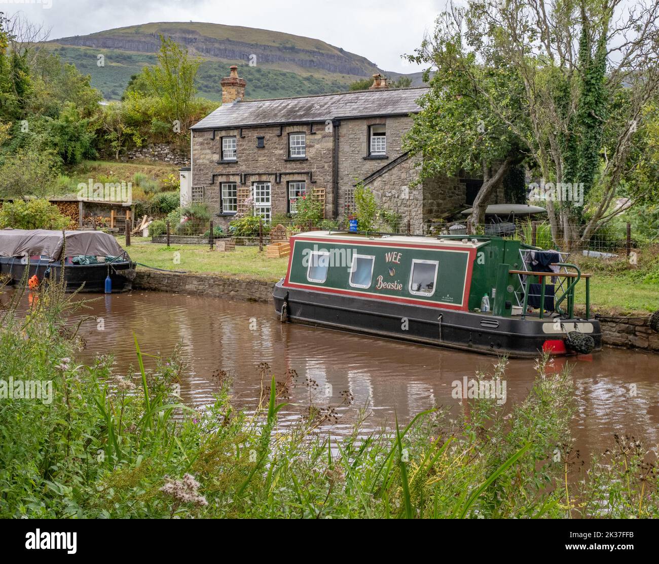 Canal barges and cottages on the Monmouthshire and Brecon Canal in the Brecon Beacons National Park near Crickhowell South Wales Stock Photo