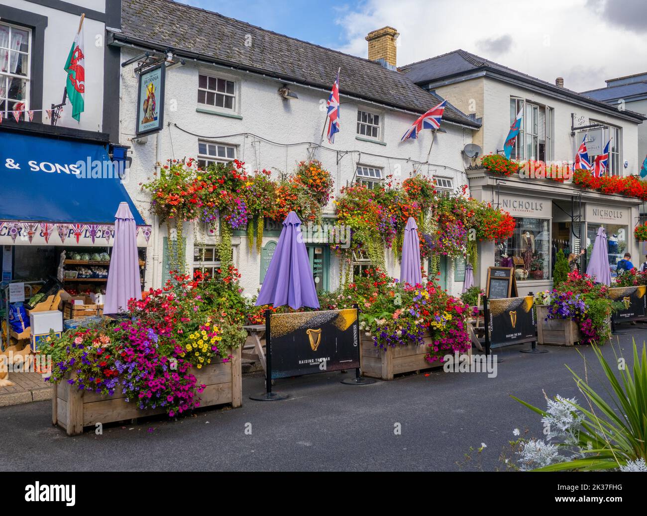 Flower-decked Britannia pub and High Street in Crickhowell in the Brecon Beacons South Wales UK Stock Photo