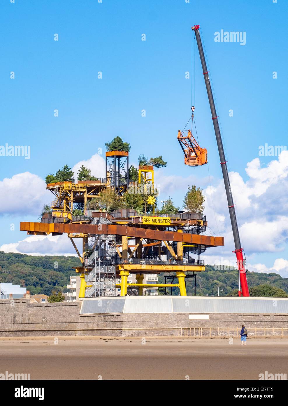 Workmen putting the finishing touches to the See Monster attraction on a gas rig installed in the Tropicana site in Weston super Mare Somerset UK Stock Photo