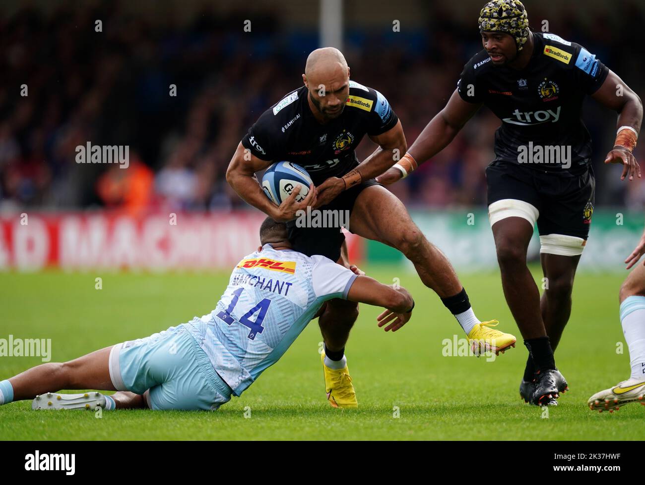 Exeter Chiefs' Olly Woodburn (centre) is tackled by Harlequins' Joe Marchant (left) during the Gallagher Premiership match at Sandy Park, Exeter. Picture date: Sunday September 25, 2022. Stock Photo