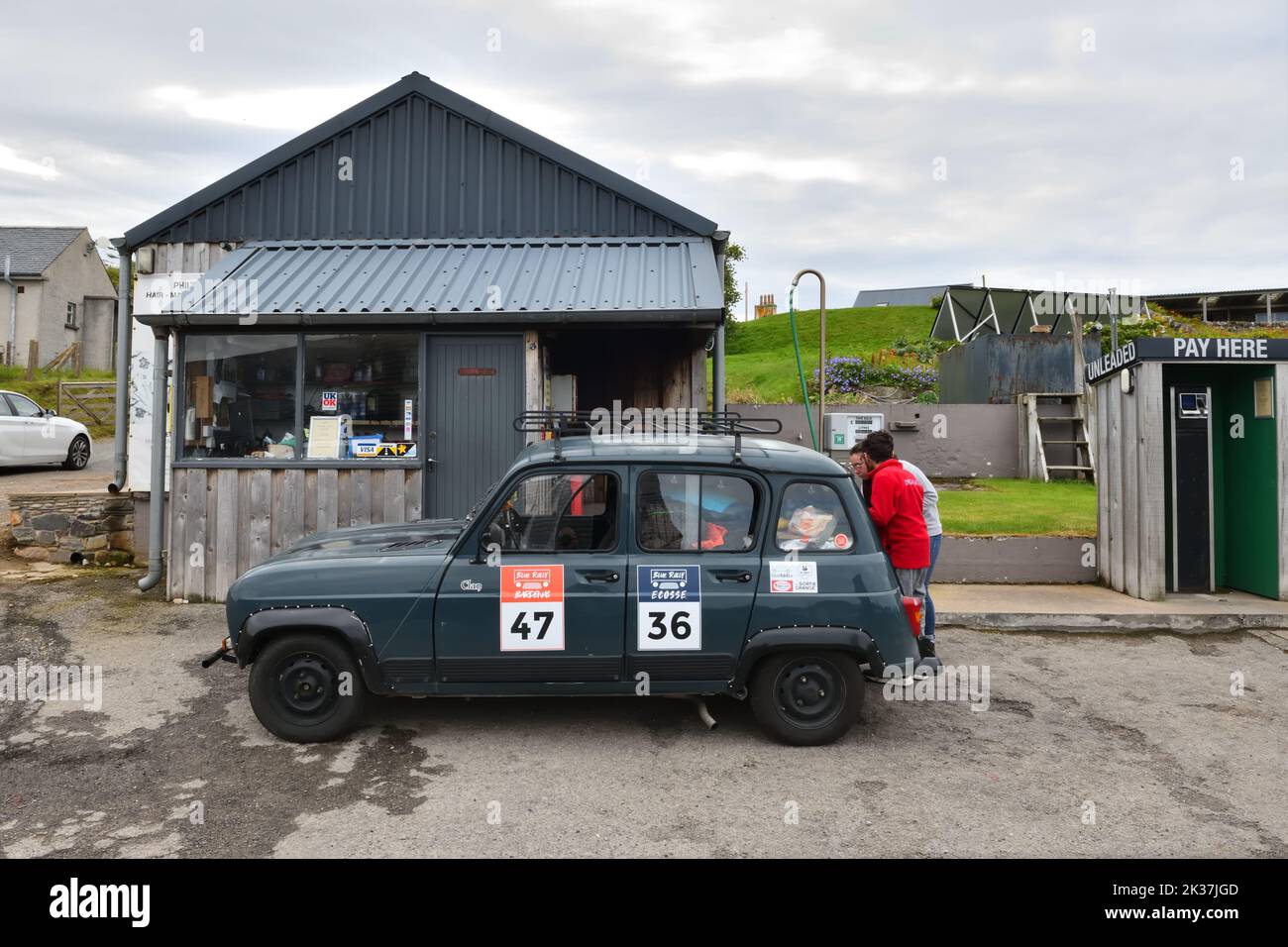 A Renault 4L CLAN filling up at a small petrol station during the 'Blue Rally' Rain in Durness, Scotland. Stock Photo