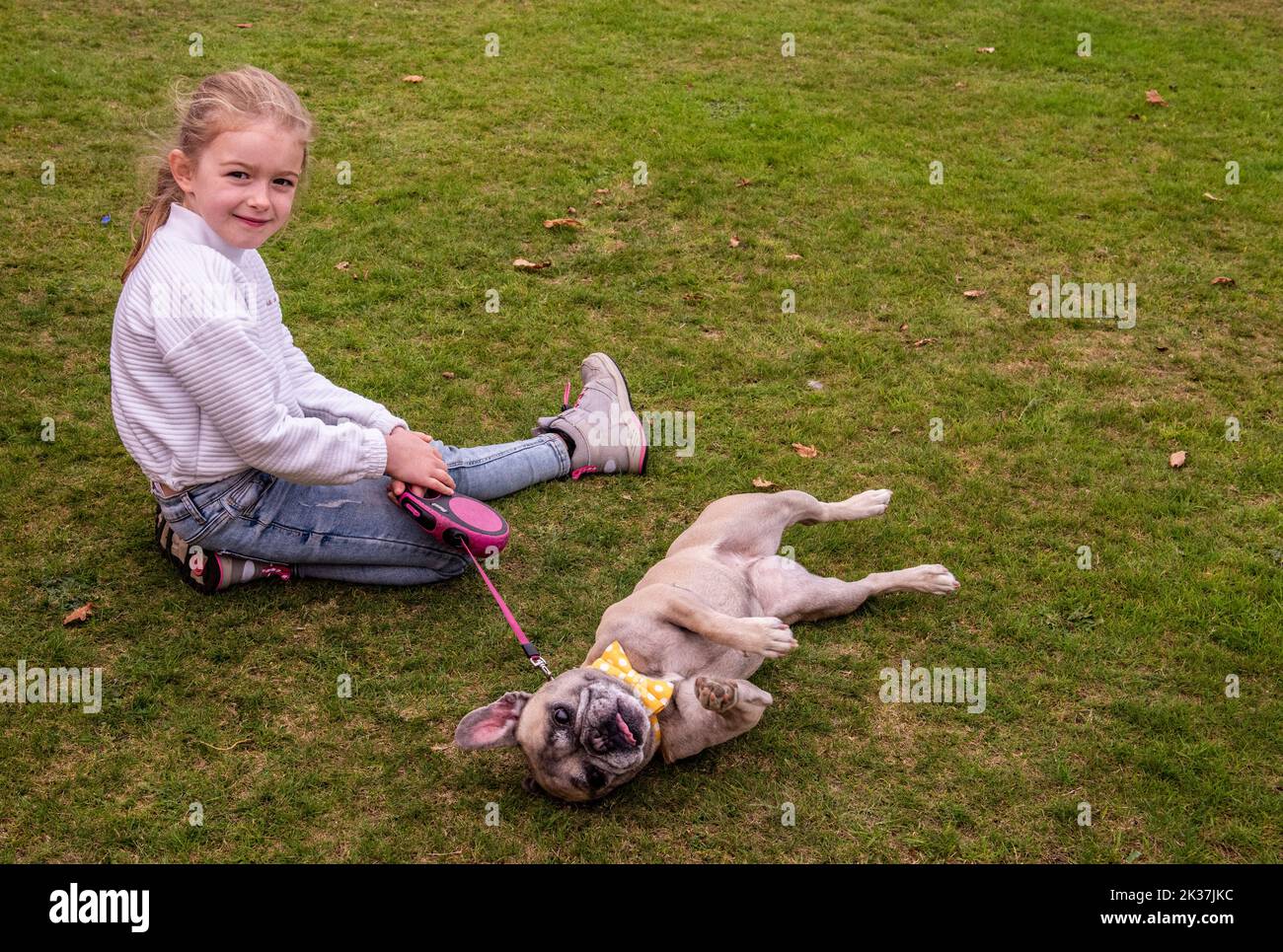 Follifoot, near Harrogate, North Yorkshire, 25th September 2022. The Follifoot Dog Festival where dog lovers were able to show off their beloved pets today. Bulldog Luna posing with young owner Mila. Picture Credit: ernesto rogata/Alamy Live News Stock Photo