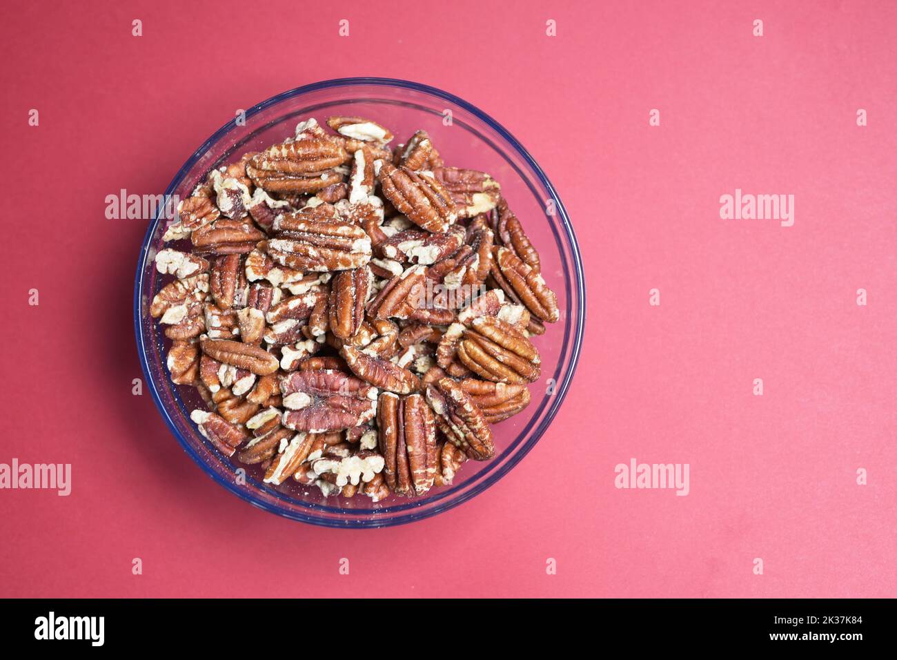 walnut in a bowl on red background  Stock Photo