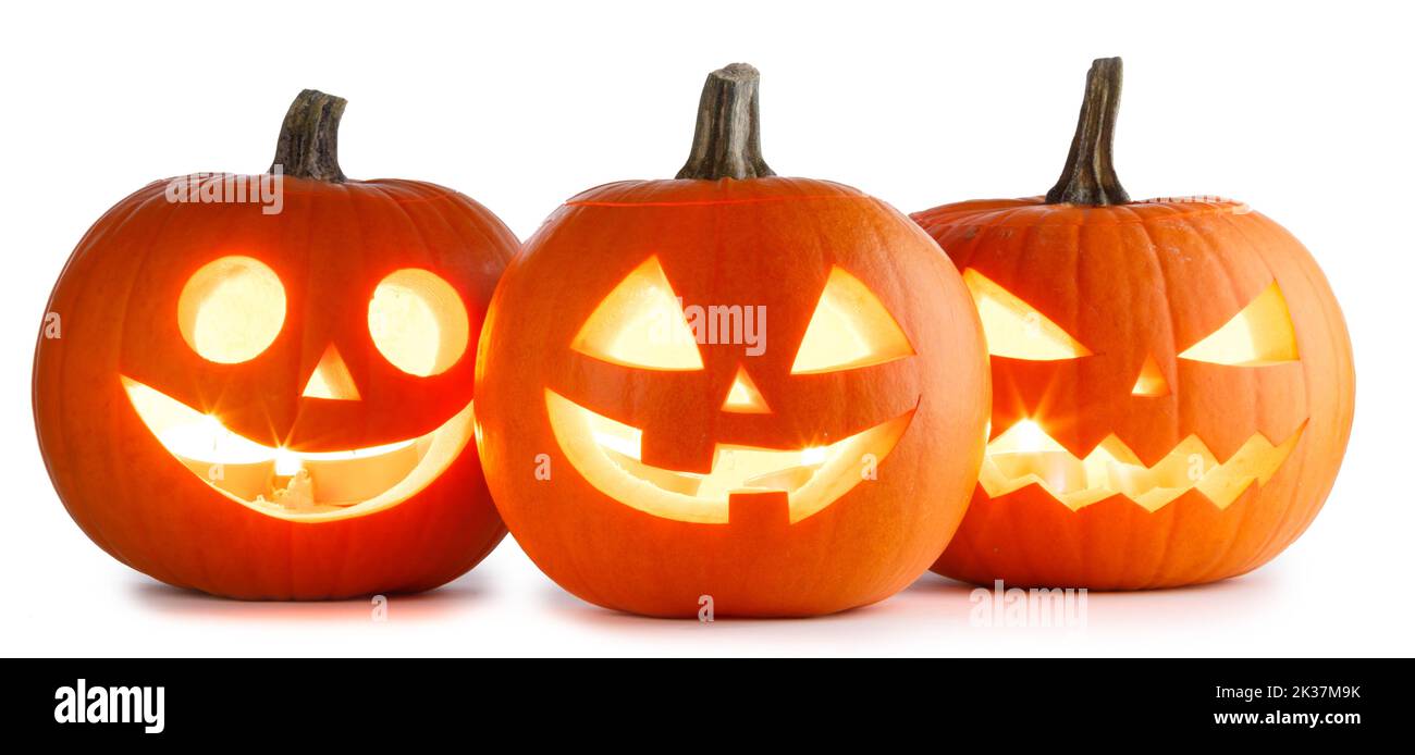 Three Halloween glowing lantern pumpkins in a row isolated on white background Stock Photo