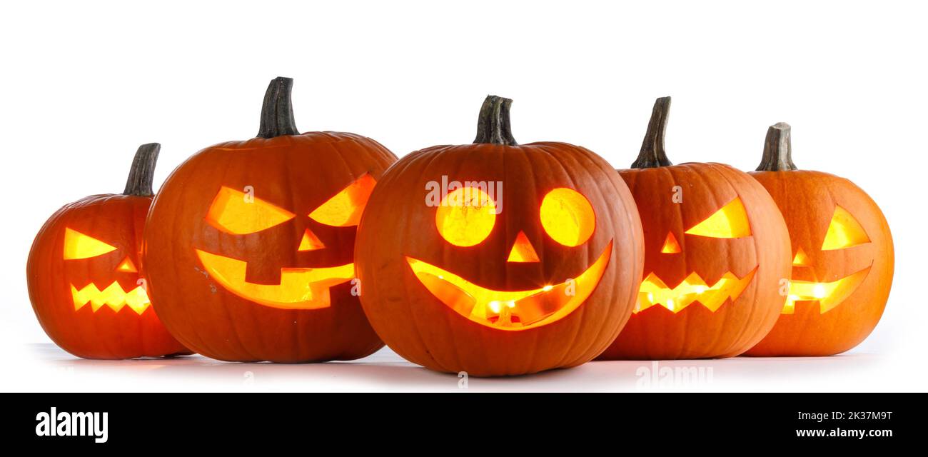 Five Halloween glowing lantern pumpkins in a row isolated on white background Stock Photo