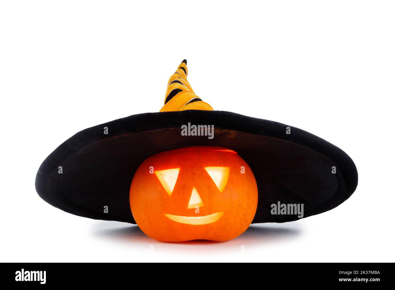 Funny Jack O Lantern Halloween pumpkin wearing witches hat isolated on white background Stock Photo