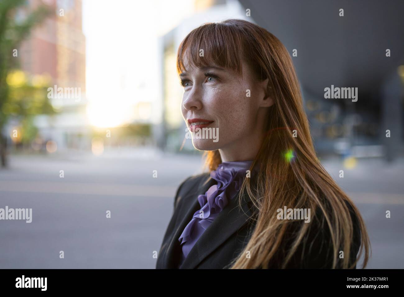 Portrait ambitious businesswoman on city street Stock Photo