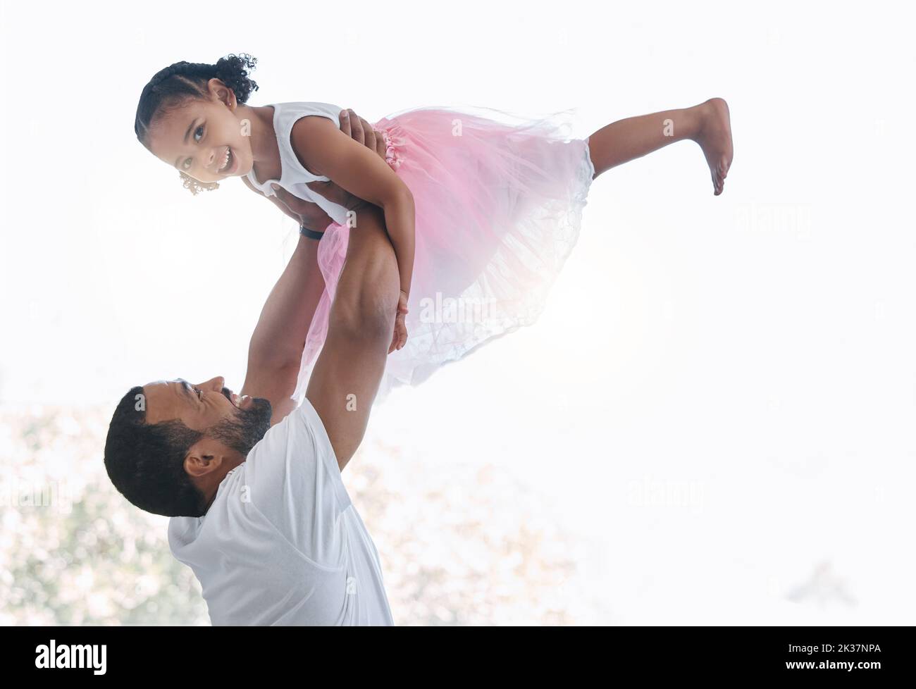 Family, dad and ballet girl happy and joyful with parent holding her in air for play time together. Trust, love and respect in childhood bond with Stock Photo