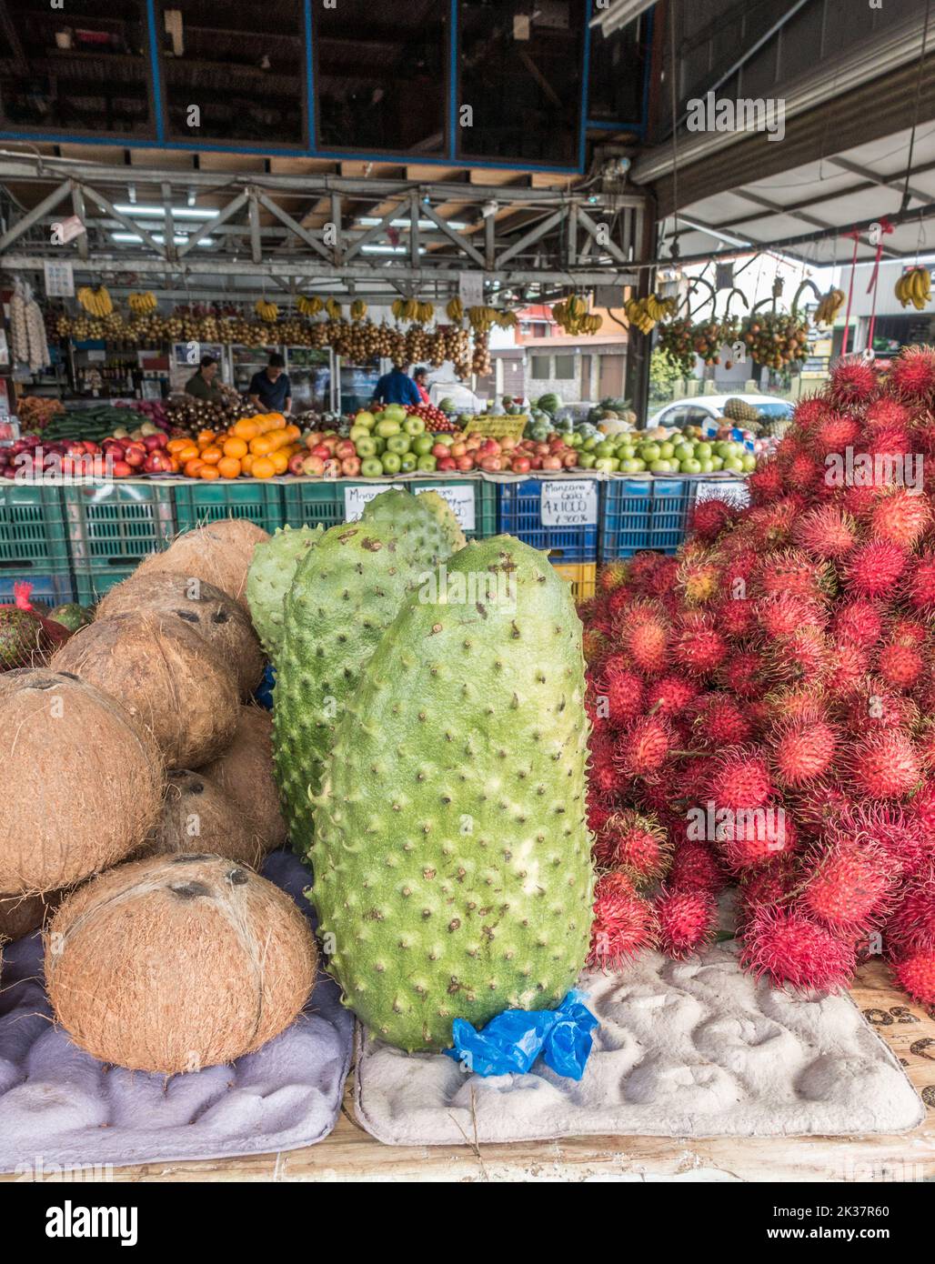 Soursop (Annona muricata), Rambutan (Nephelium lappaceum), Coconuts for sale at a market in Costa Rica. Stock Photo