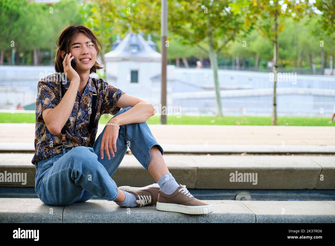 Asian guy talking on the smartphone at street. Stock Photo