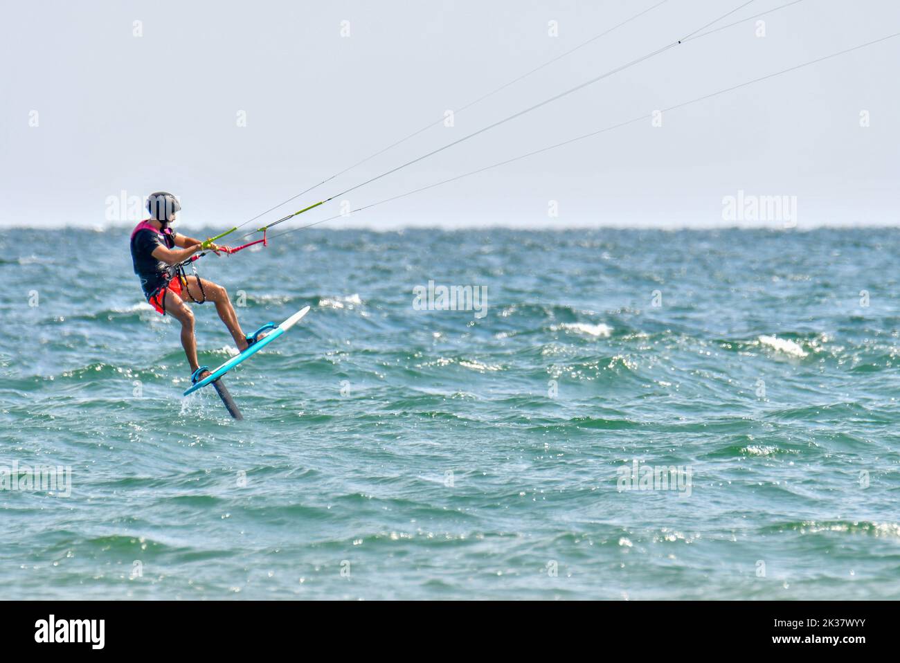 A kitesurfer sailing in the Mediterranean Sea Stock Photo
