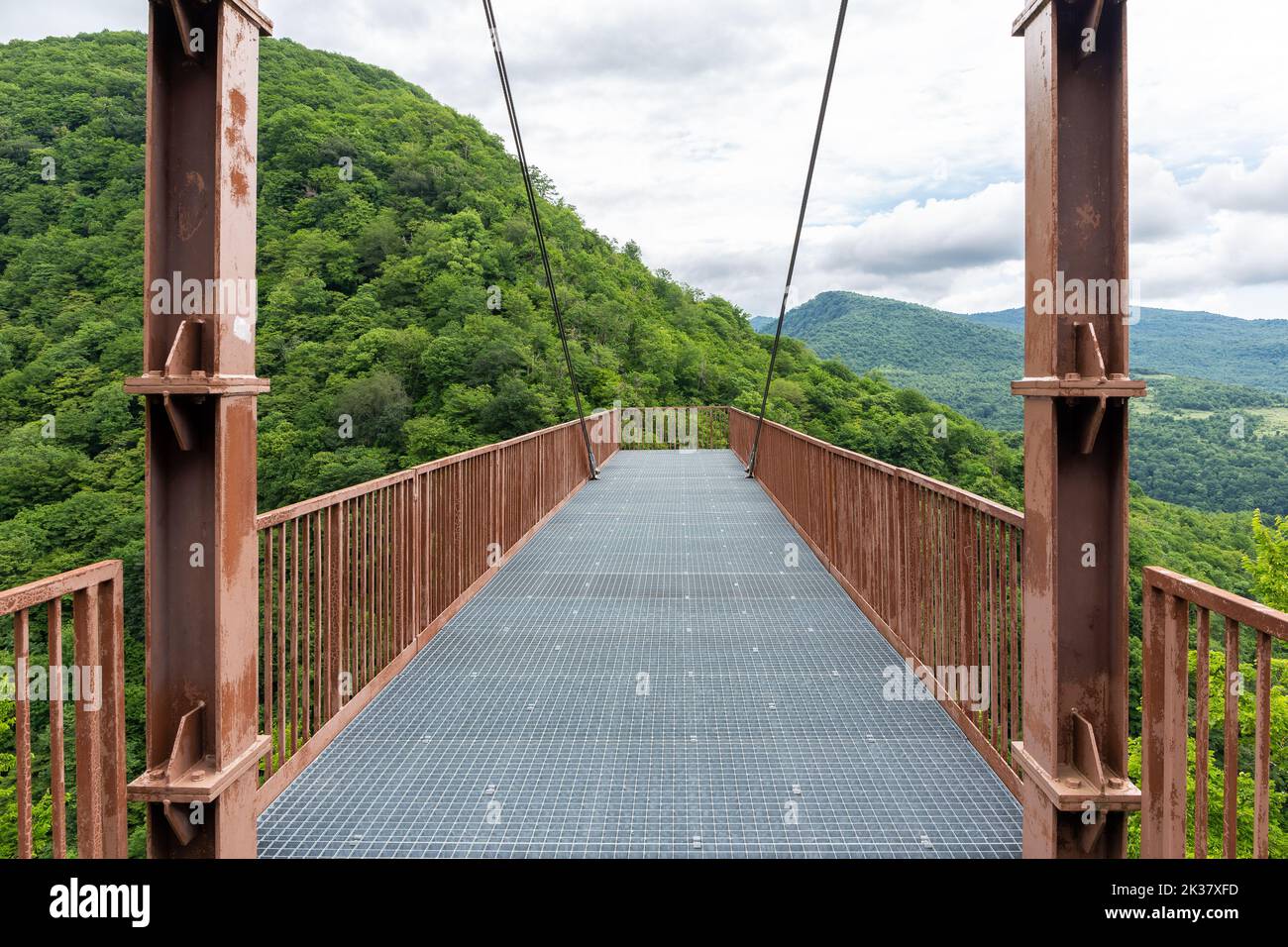 Metal hanging viewing platform above Okatse Canyon in Georgia, lush vegetation and forests, no people. Stock Photo