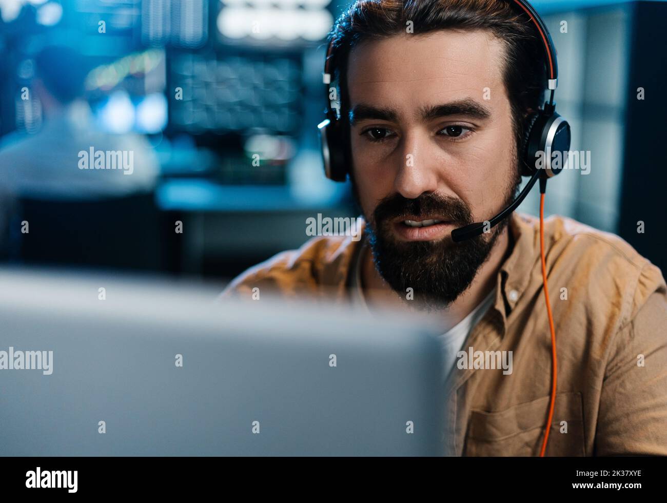 Young stock exchange trader working in dark office Stock Photo