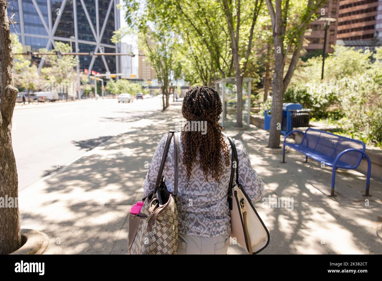 Woman walking on sidewalk hi-res stock photography and images - Alamy