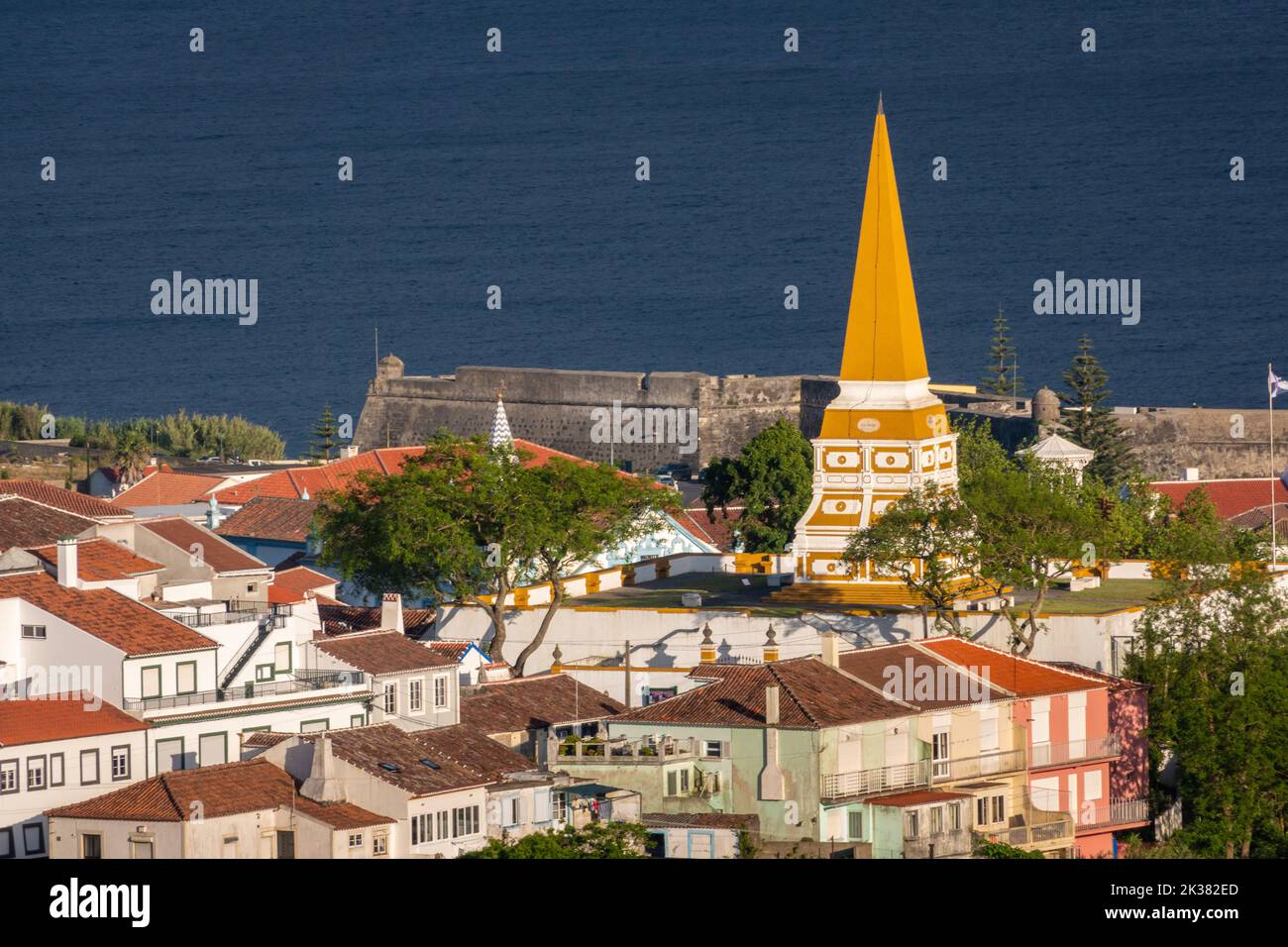 Outeiro da Memoria, a monument erected in honor of King Pedro IV in 1846, dominates the skyline looking toward the Bay of Angra in Angra do Heroismo, Terceira Island, Azores, Portugal. Stock Photo