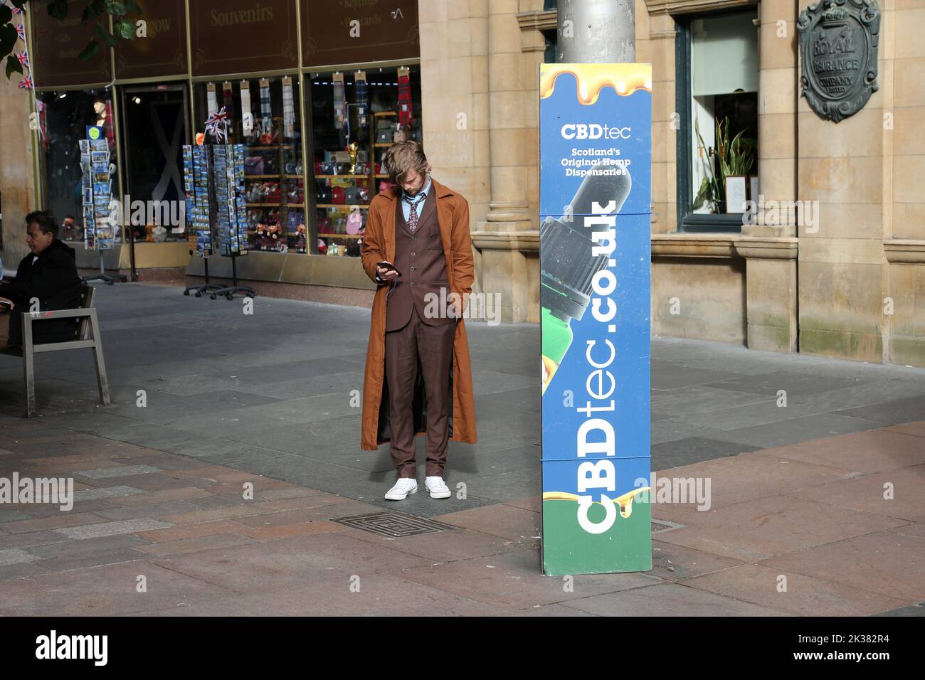 Buchanan St, Glasgow, Scotland, UK. Police Box painted in original blue. Now converted to a small retail unit selling CBD Oils Concentrates Edibles. CBDtec Scotland's Original Dispensaries. Cannabis Trades Association.Man standing near by looks like the Scottish Actor David Tennant dressed as Dr Who Stock Photo