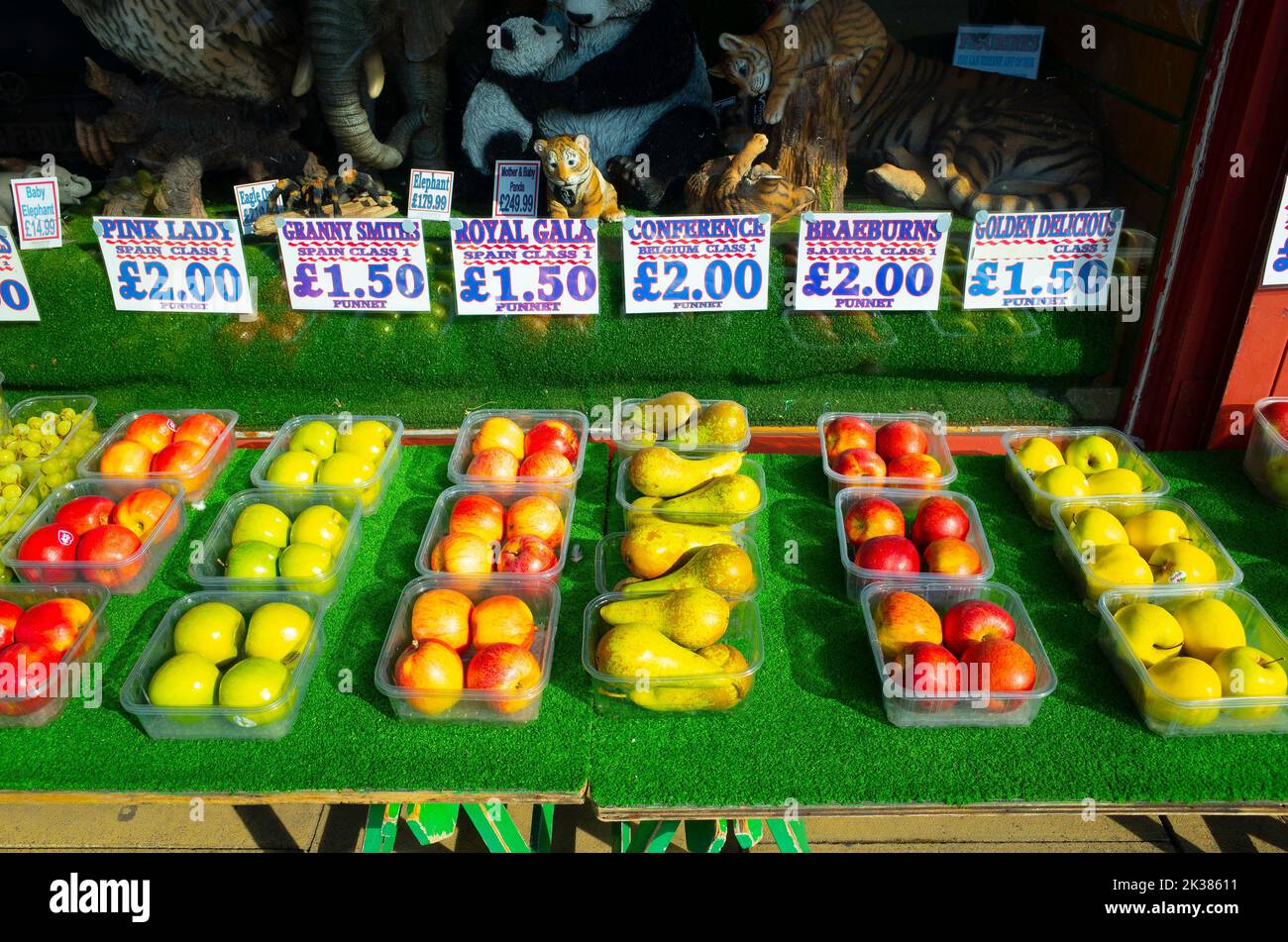Apples and pears sold by the punnet priced on a greengrocers window front display Stock Photo