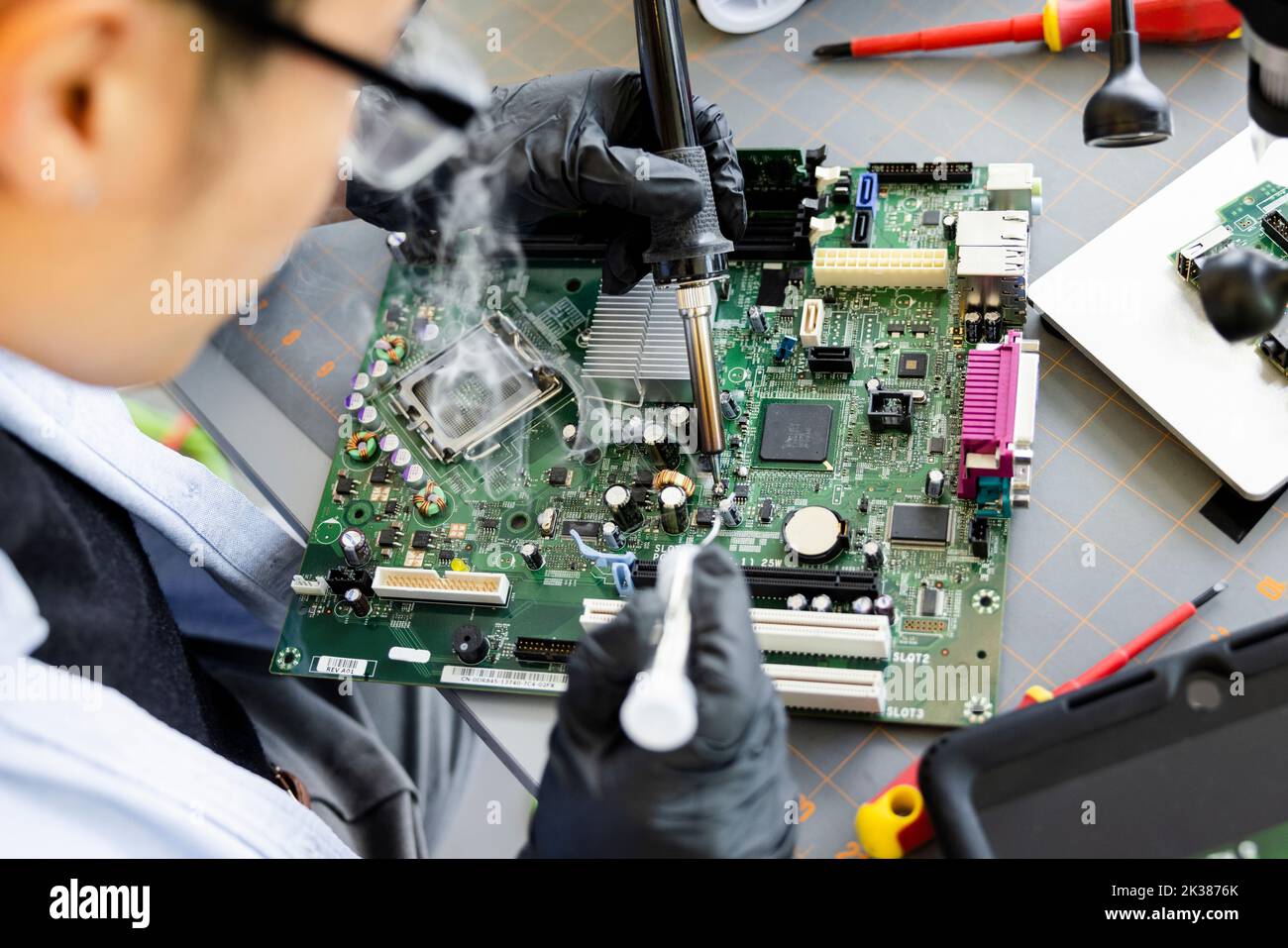 Engineer with soldering iron assembling circuit board Stock Photo Alamy