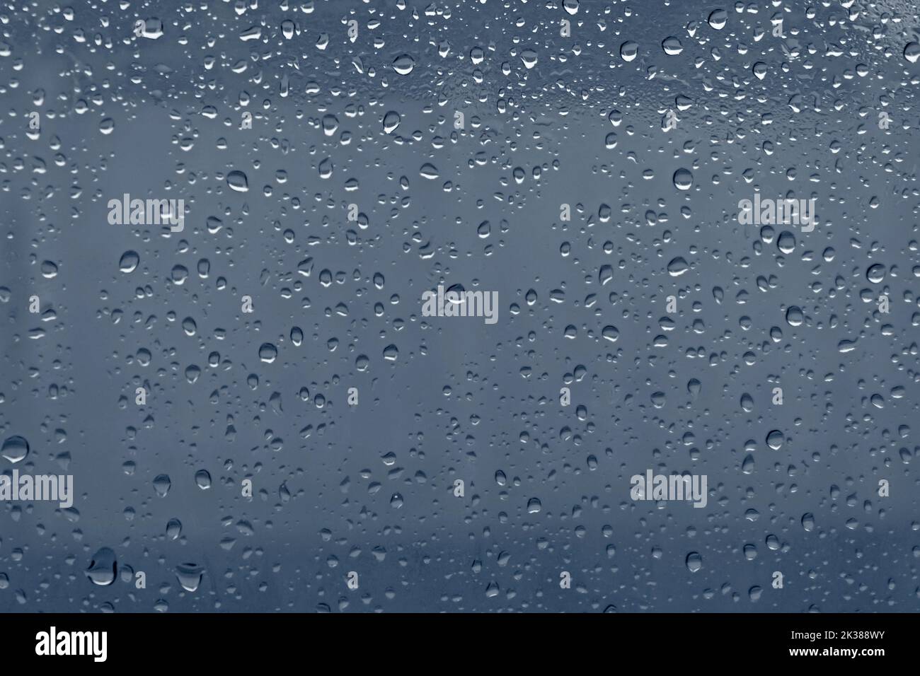 close up of rain drops on blue glass Stock Photo