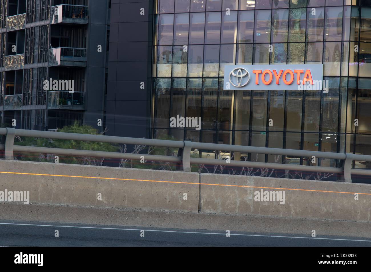 The Toyota logo on the side of a downtown Toronto dealership while illuminated at dawn. Stock Photo