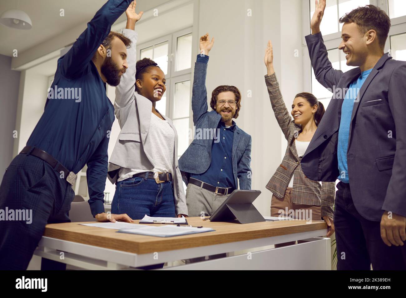Happy diverse business team celebrating success and having fun in a work meeting Stock Photo