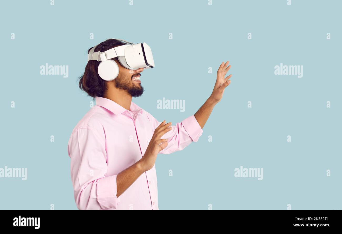 Smiling man in VR glasses enjoy modern technologies Stock Photo