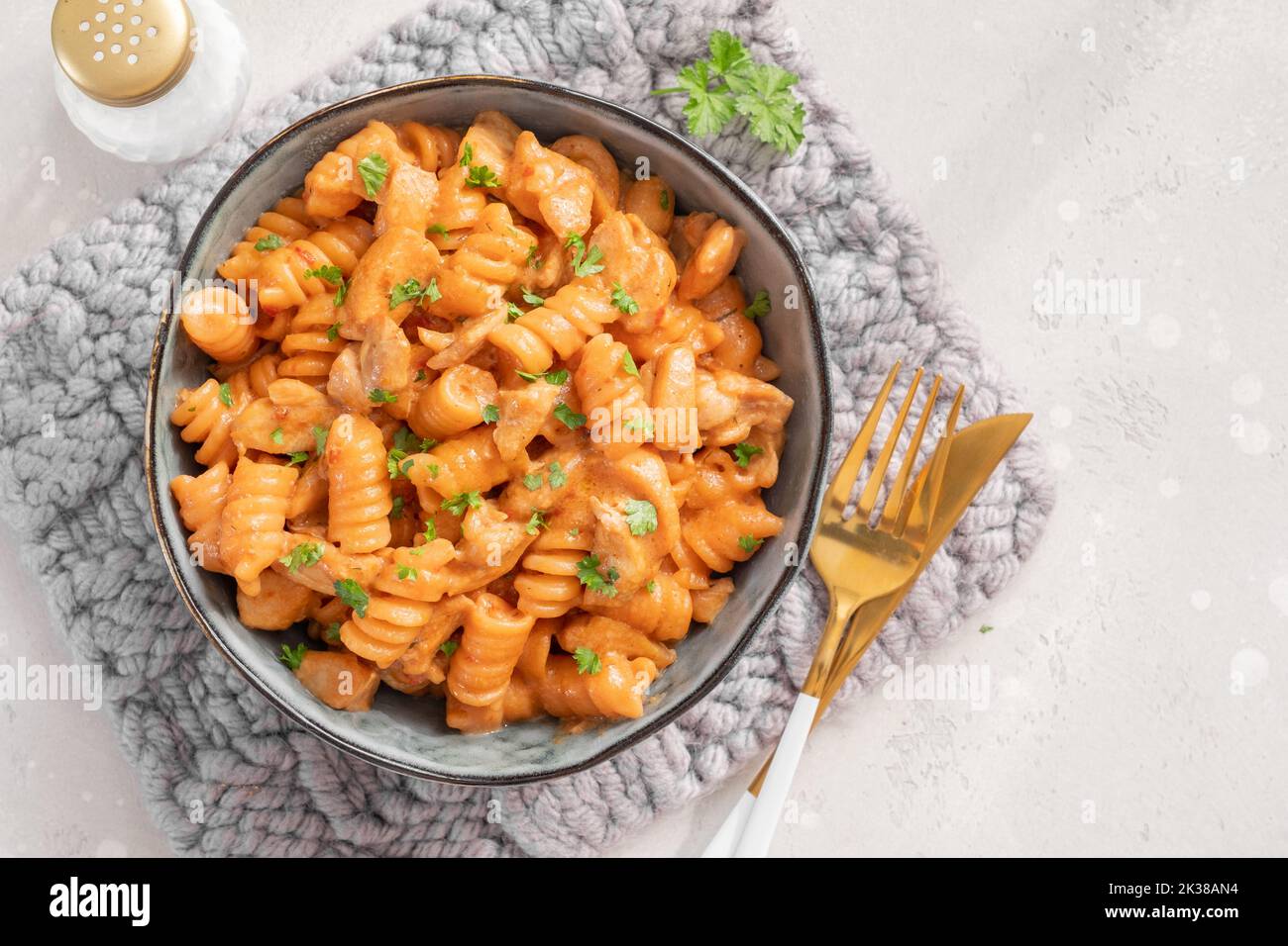 Fusilli pasta with chicken. Cooked in spicy sauce from tomatoes, onion, garlic with chicken meat Stock Photo
