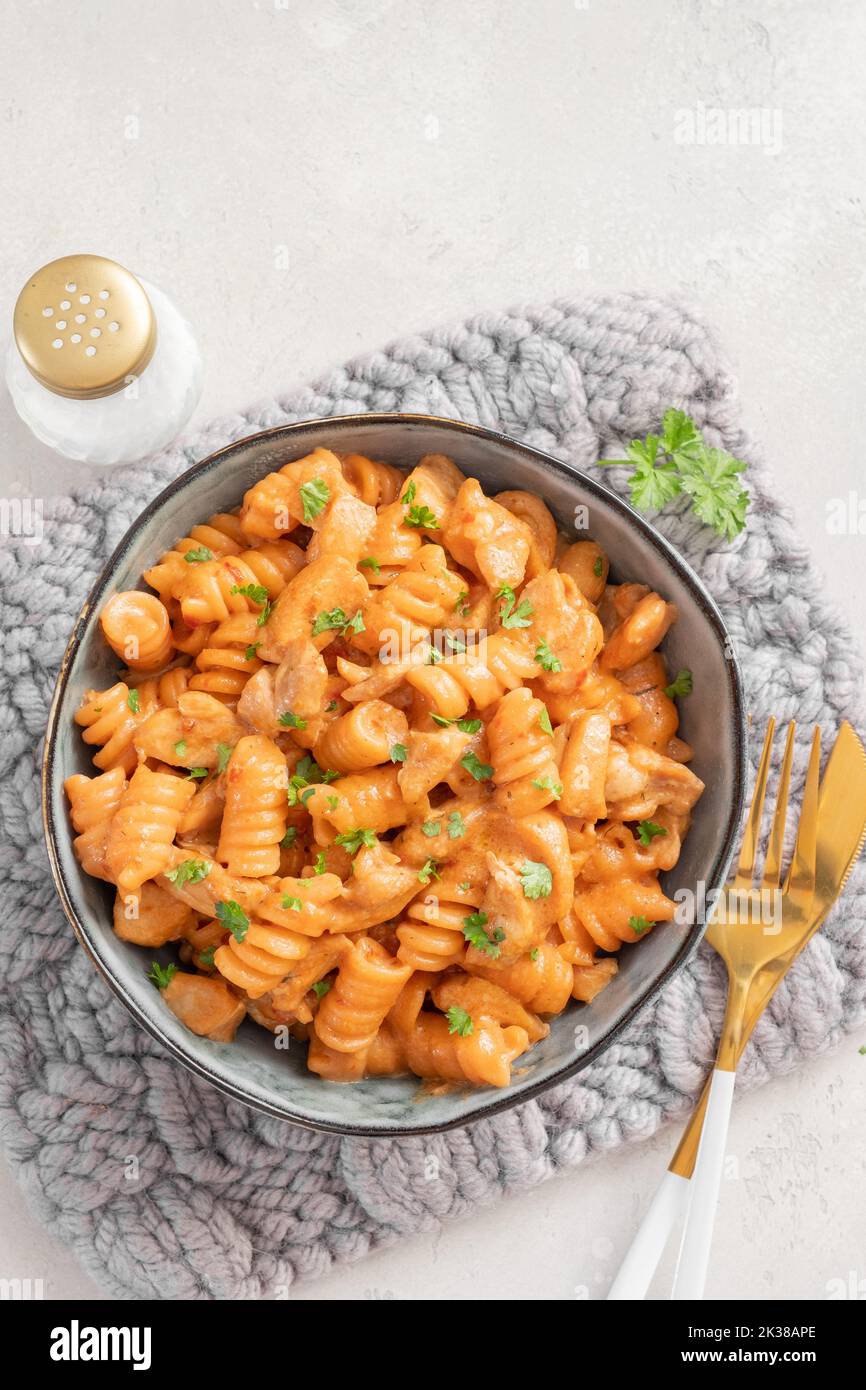 Fusilli pasta with chicken. Cooked in spicy sauce from tomatoes, onion, garlic with chicken meat Stock Photo