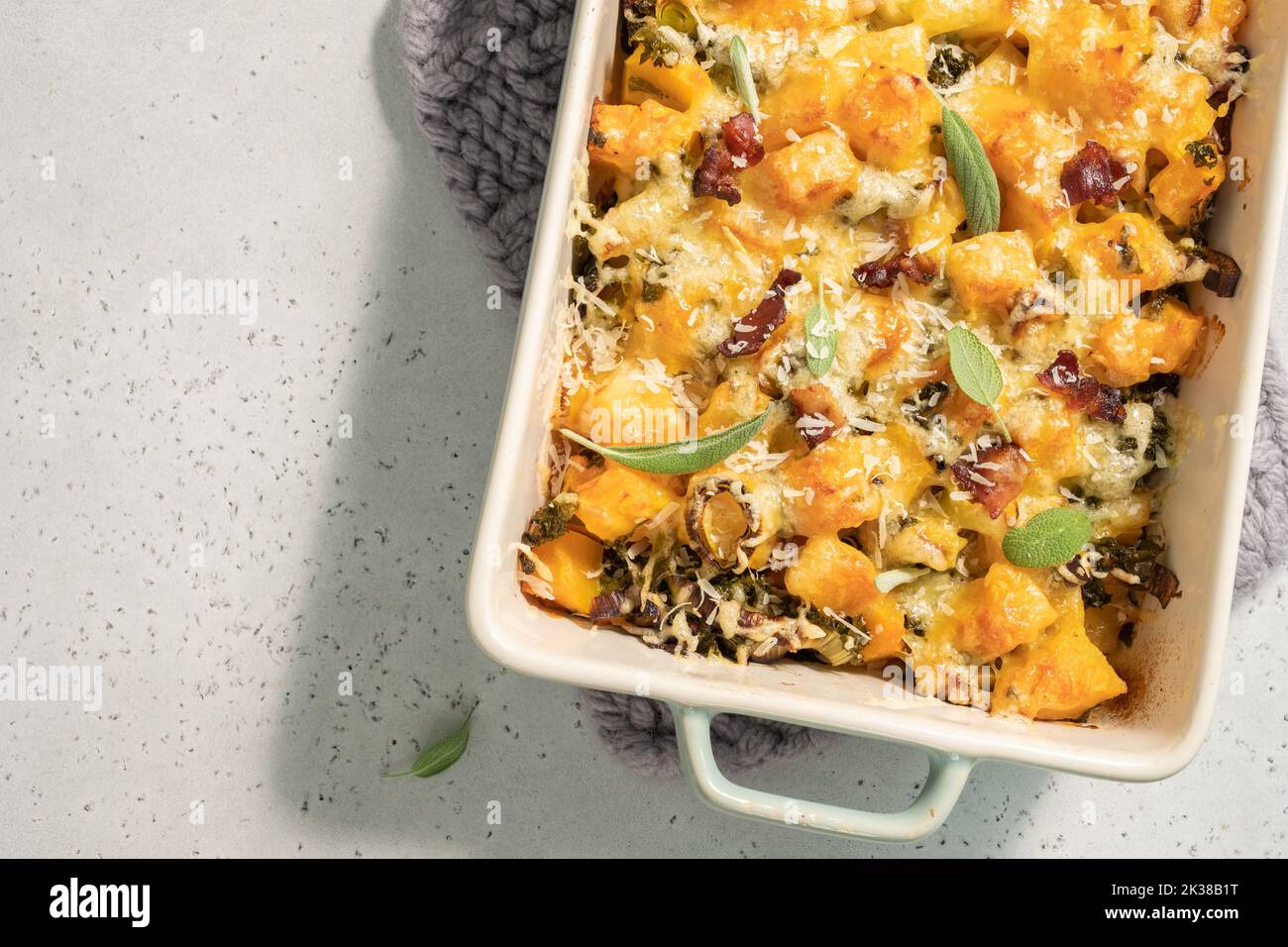 Autumn pumpkin casserole with leek, bacon, cheese and kale Stock Photo