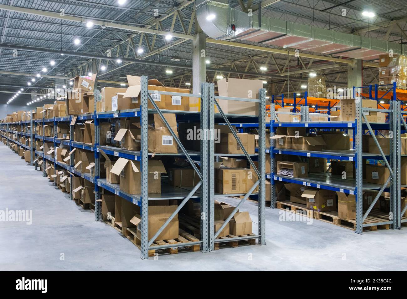 warehouse interior with cardboard boxes on shelves close up Stock Photo ...