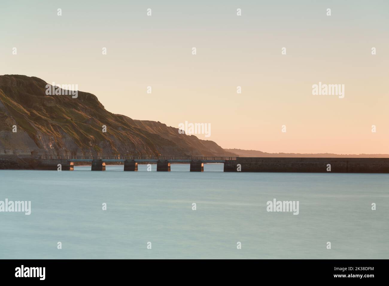 A long exposure image of the Harbour and sea wall defences at Port-en-Bessin, Normandie. Stock Photo