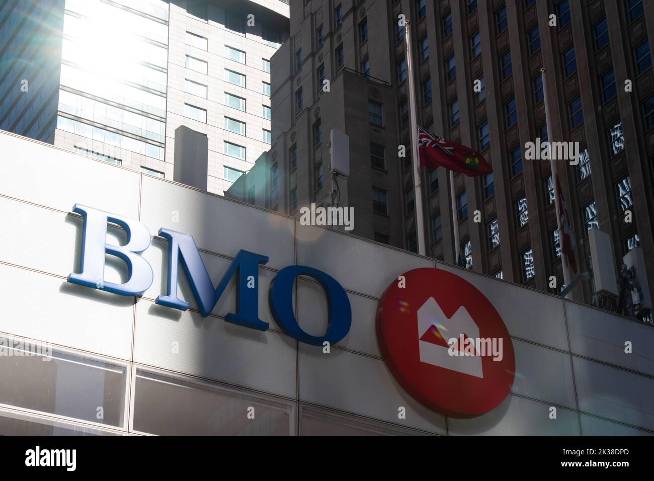 The morning sun shines off a high-rise building in downtown Toronto, glaring down on the BMO logo atop their HQ; BMO is part of Canada's Big 5 banks, Stock Photo