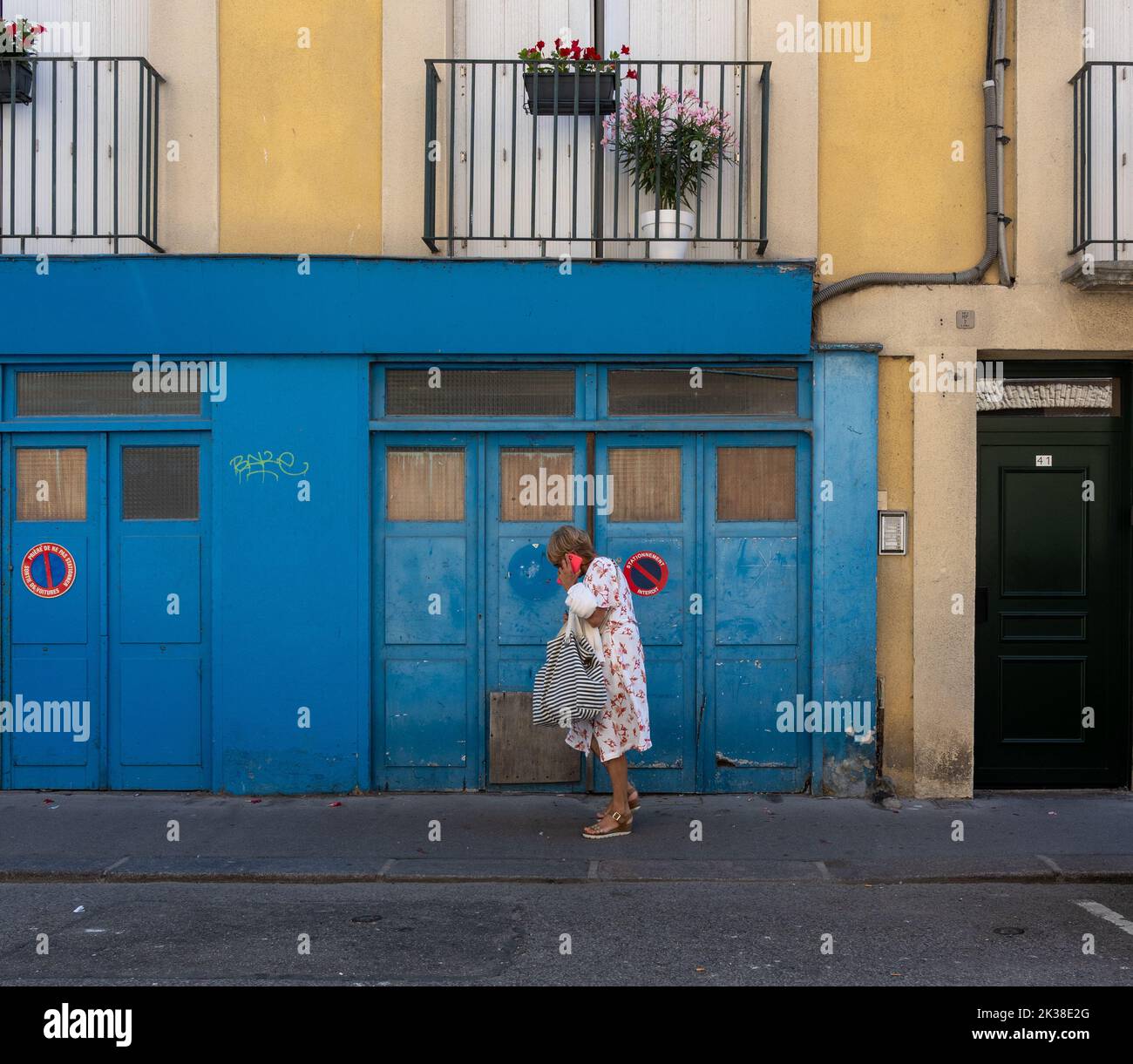 A women looking into her handbag on the street in Dieppe. Stock Photo