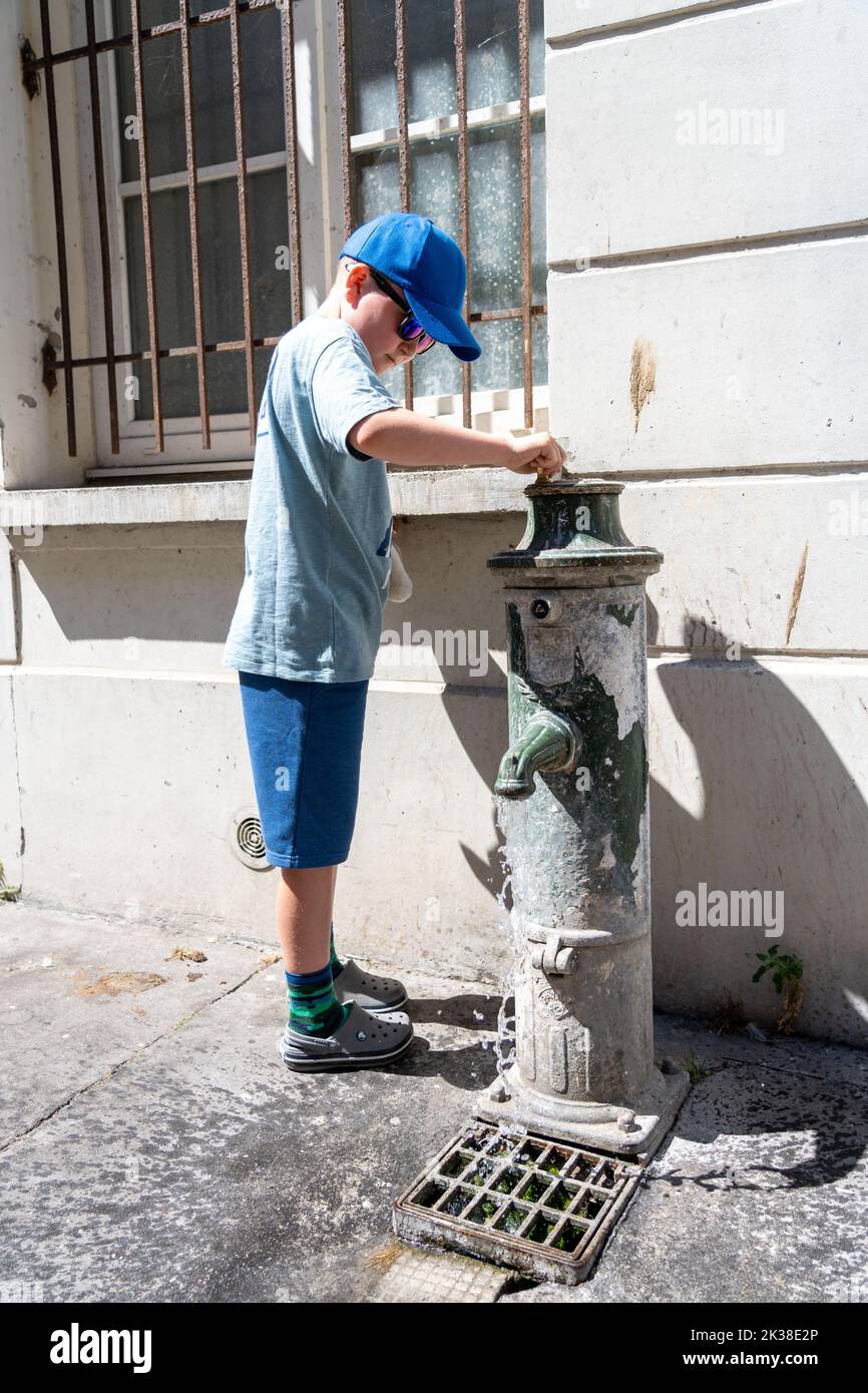 Young boy playing with a water hydrant. Stock Photo