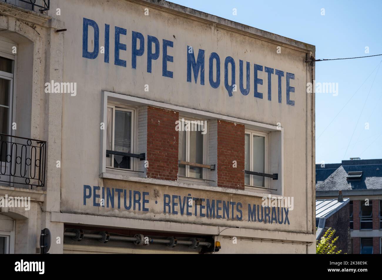 Old advertising painted on the façade of a building in Dieppe. Stock Photo