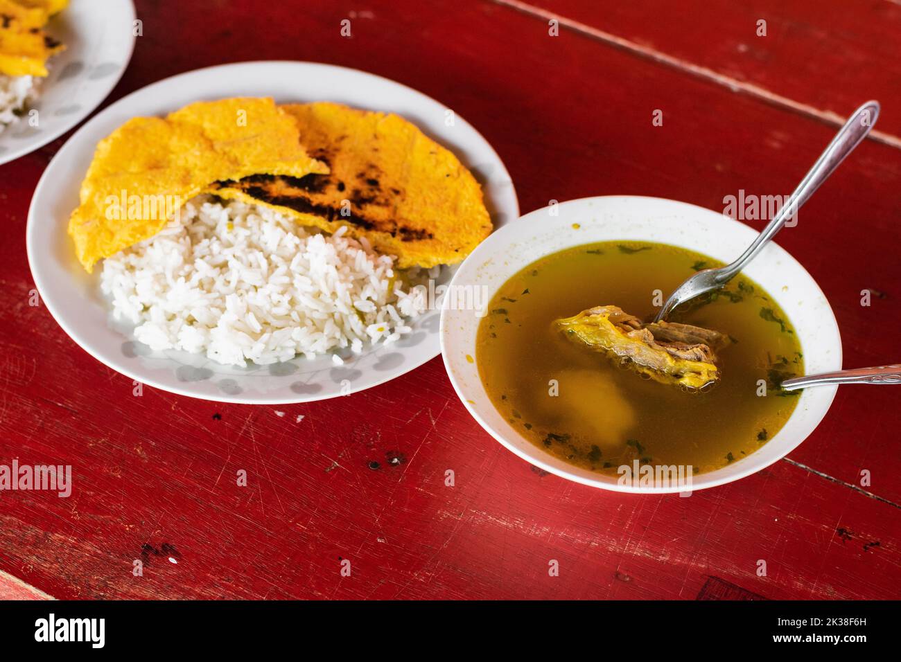 view from above of a delicious colombian breakfast made with beef broth, rice, yellow arepa and natural spices such as coriander and cimarron. typical Stock Photo