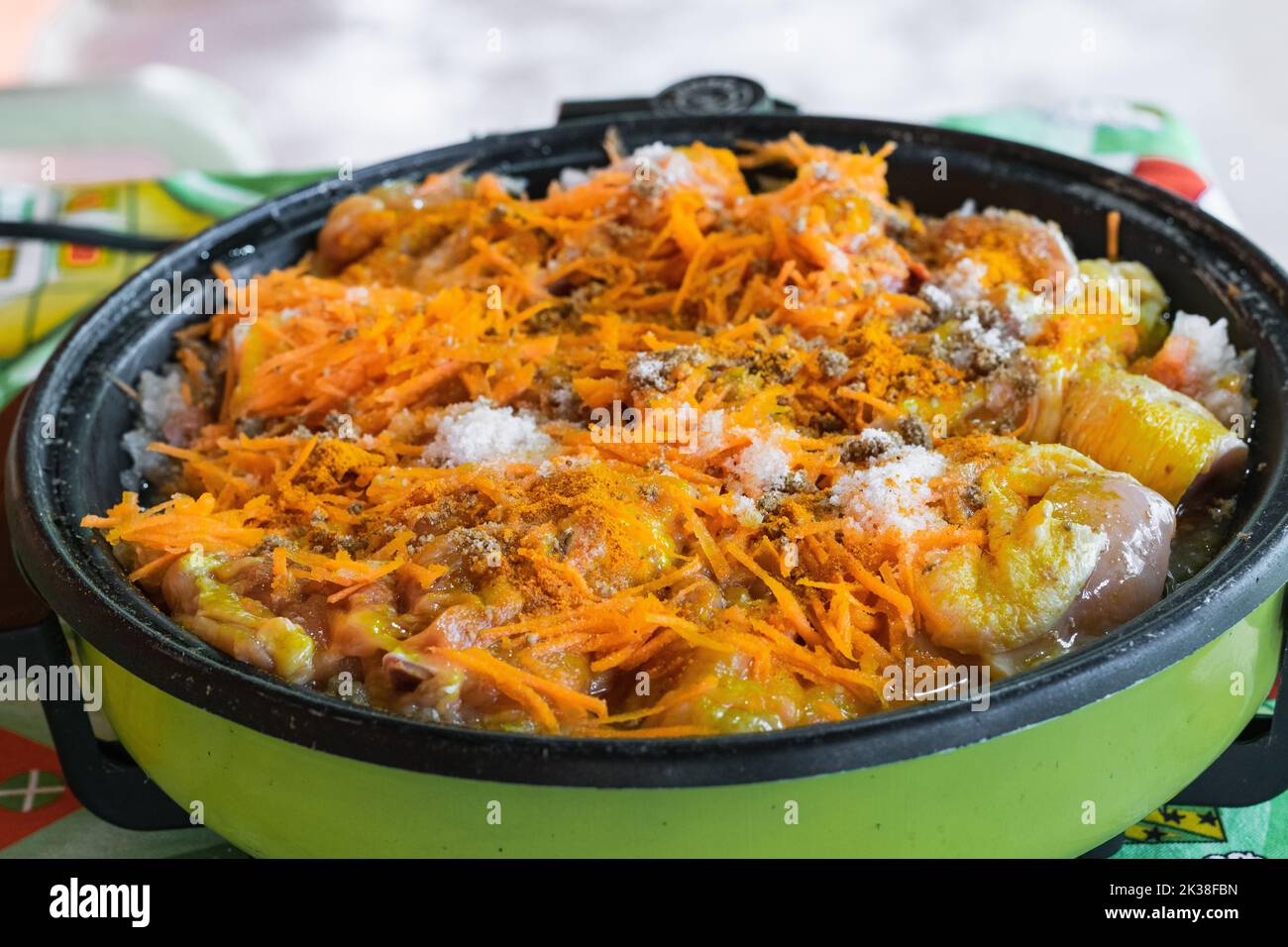 cooking detail shot of a typical colombian dish, Sudao of chicken seasoned with natural spices and grated carrot. cooking in electric grill. colombian Stock Photo