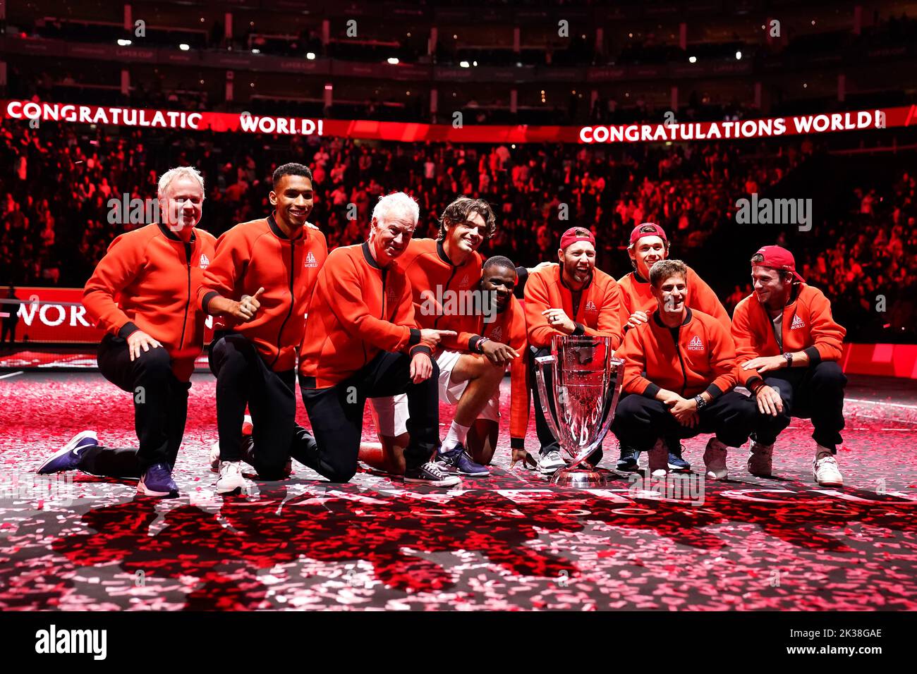 Team World (left to right) vice captain Patrick McEnroe, Felix Auger Aliassime, captain John McEnroe, Taylor Fritz, Frances Tiafoe, Jack Sock, Alex De Minaur, Diego Schwartzman and Tommy Paul as they celebrate with the trophy after winning the Laver Cup on day three of the Laver Cup at the O2 Arena, London. Picture date: Sunday September 25, 2022. Stock Photo