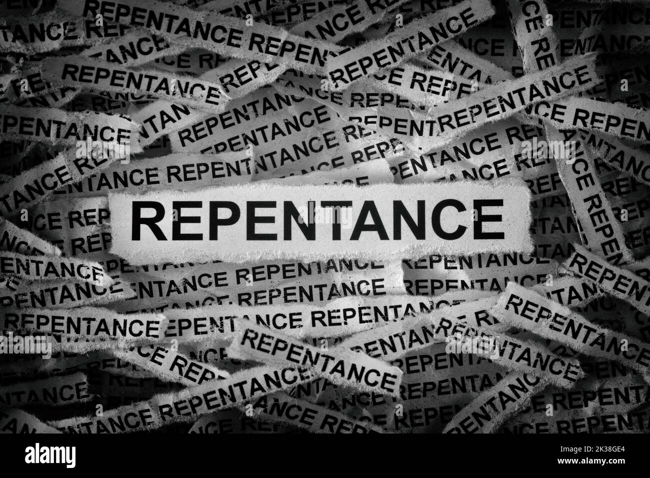 Strips of newspaper with the words Repentance typed on them. Black and white. Close up. Stock Photo