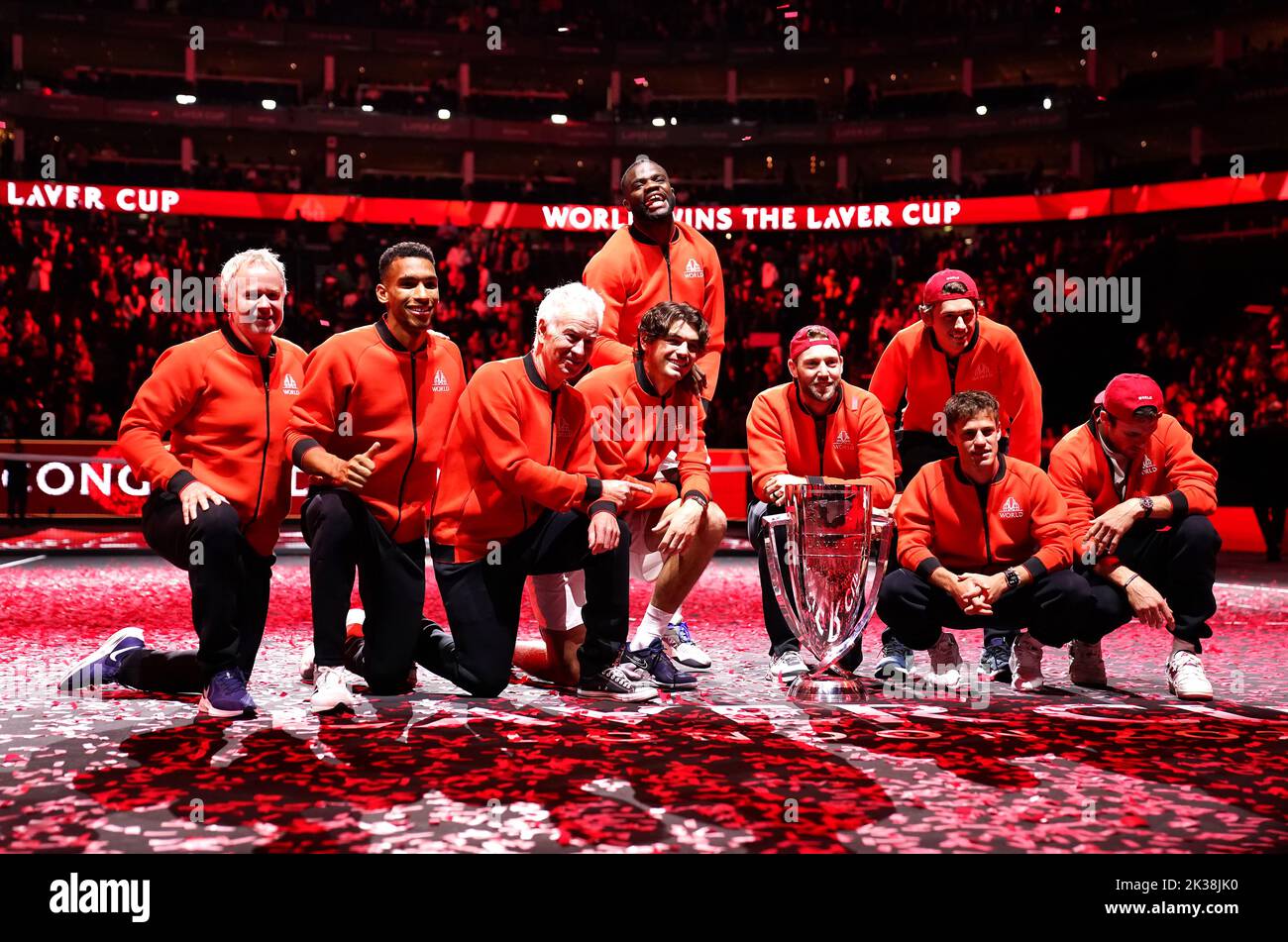 Team World (left to right) vice captain Patrick McEnroe, Felix Auger Aliassime, captain John McEnroe, Taylor Fritz, Frances Tiafoe, Jack Sock, Alex De Minaur, Diego Schwartzman and Tommy Paul as they celebrate with the trophy after winning the Laver Cup on day three of the Laver Cup at the O2 Arena, London. Picture date: Sunday September 25, 2022. Stock Photo