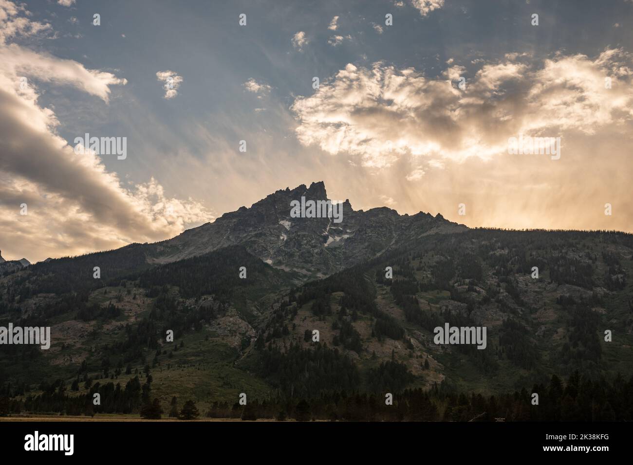 Setting Sun Backlights Teton Mountains in Wyoming Stock Photo