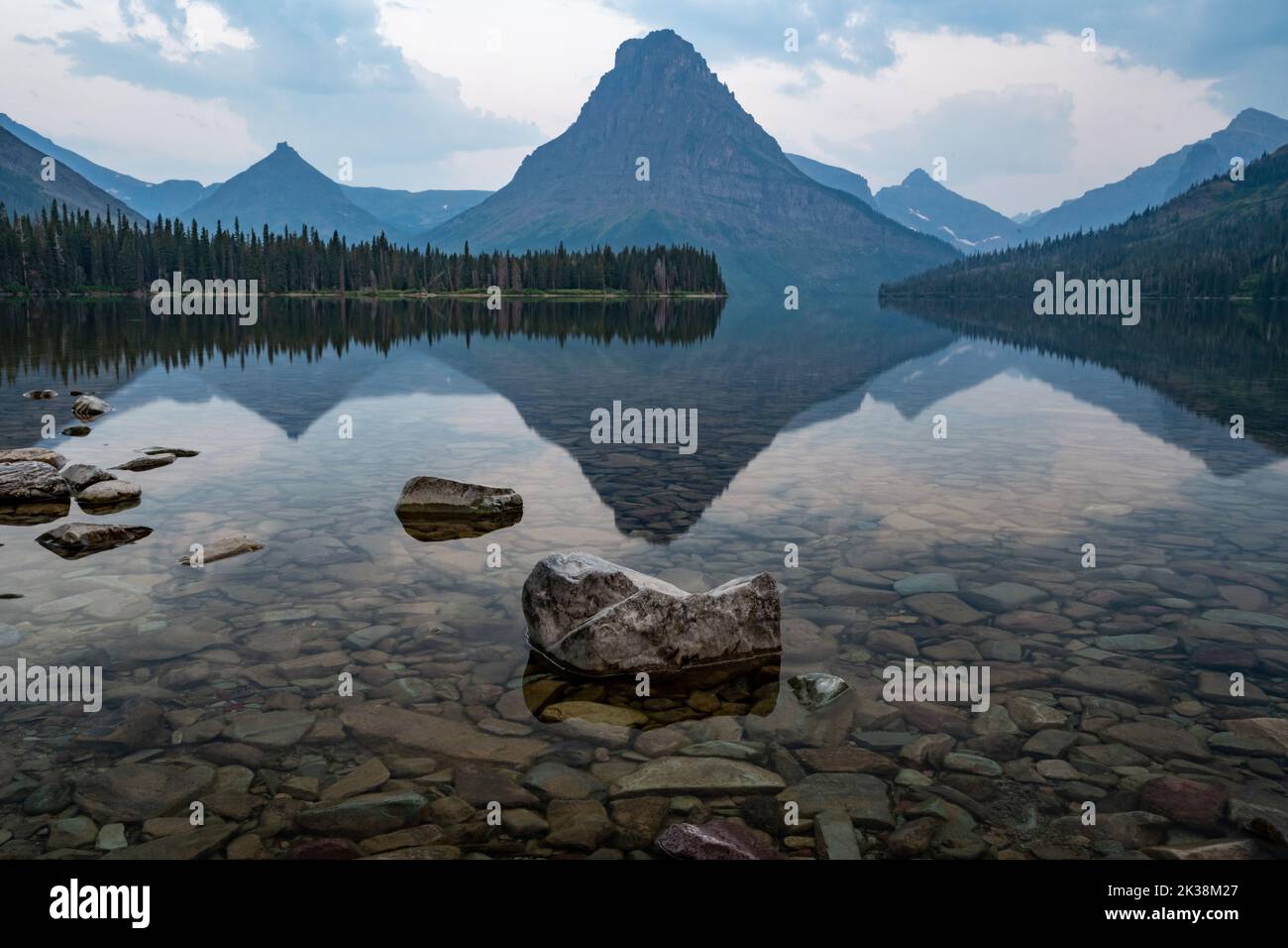 Sinopah Mountain Reflects In Two Medicine Lake in Glacier National Park Stock Photo